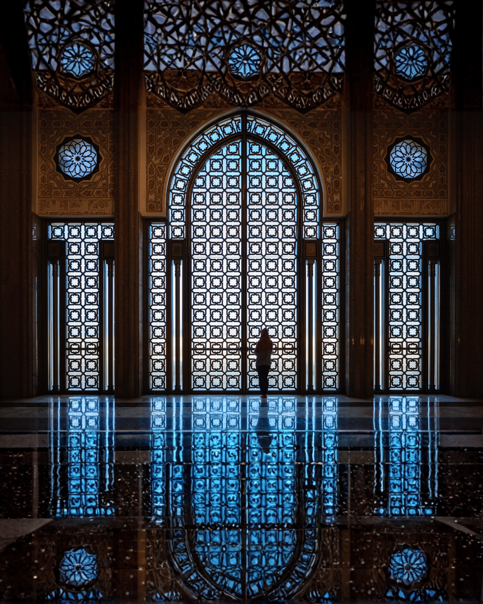 Soaring arches and patterned light inside a mosque — a symbol of hope and rising independence.